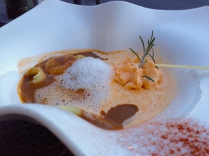 Lobster ravioli in a seafood broth dressed with a foam of cream
